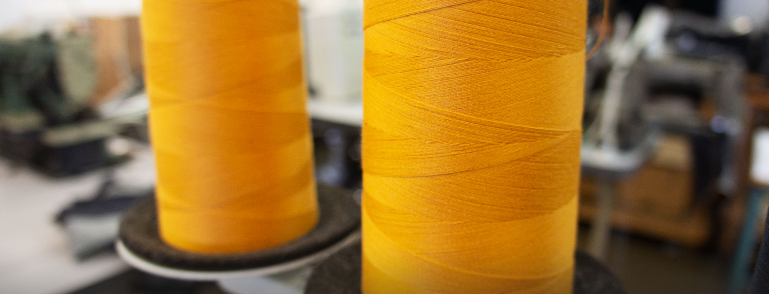 Two yellow spools of yarn